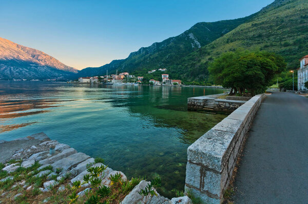 Evening in sea town on mountains background. Montenegro