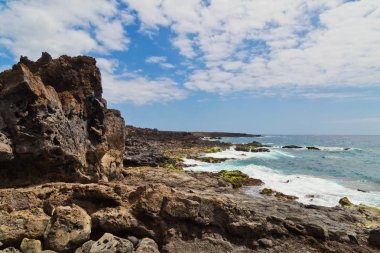 Mavi gökyüzünün altındaki taşlı sahil. Tenerife adası. İspanya