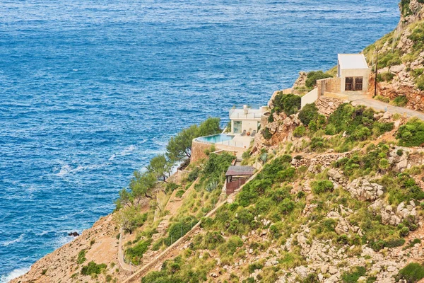 Landscape with sea and house on the mountainside under the blue sky, Mallorca, Balearic islands, Spain