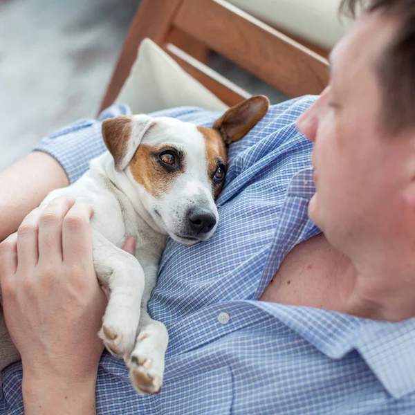 Man with dog at home. Adult man with his beloved pet