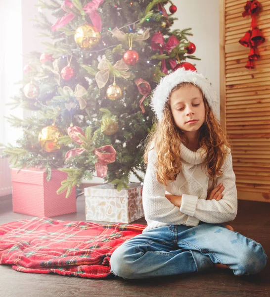 Sad child near christmas tree — Stock Photo, Image