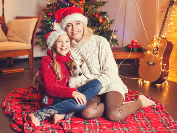 Lächeln Mädchen mit Mama in der Nähe von Weihnachtsbaum zu Hause — Stockfoto