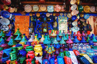 Colored Tajine, plates and pots out of clay on the market in Mor clipart