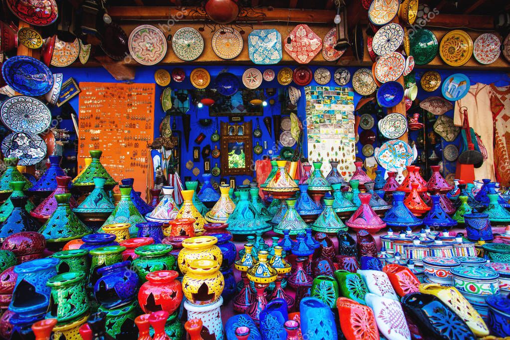Colored Tajine, plates and pots out of clay on the market of Chefchaouen in Morocco. Moroccan Medina
