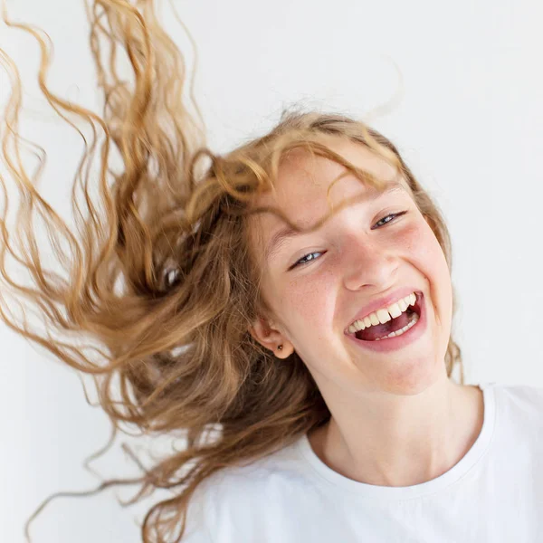 Portrait smiling young girl teen with flying curly hair — Stock Photo, Image