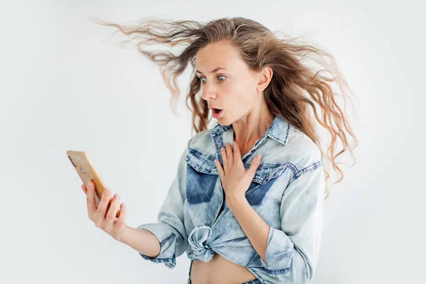 Surprised woman looking at mobile phone — Stock Photo, Image