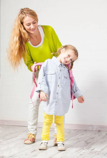 Mother helps her daughter get ready for school — Stock Photo, Image