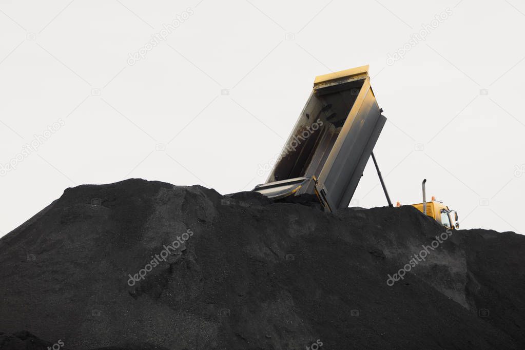 Coal mining at an open pit. Pile of black coal pieces