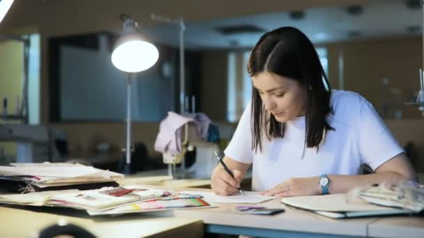 Designer draw sketches in the Studio. attractive women working and smiling. Workspace designer. White sheet of paper, pencils, markers, felt-tip pens. — Stock Video