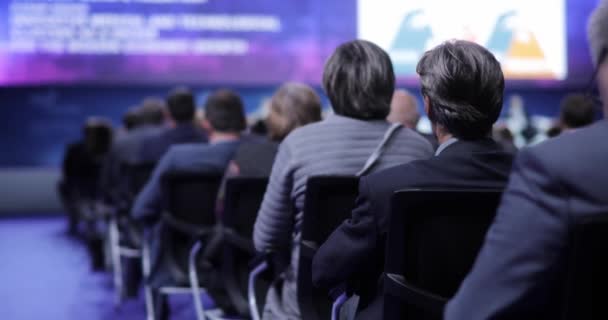 People at a conference or presentation, workshop, master class photograph. the speaker tells the speech at conference. Back view. Business and Entrepreneurship concept. — Stock Video