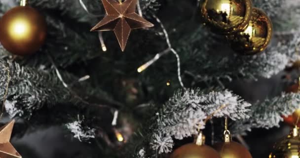 Conceito de estação de saudação.Dolly de ornamentos em uma árvore de Natal com luz decorativa e neve caindo — Vídeo de Stock