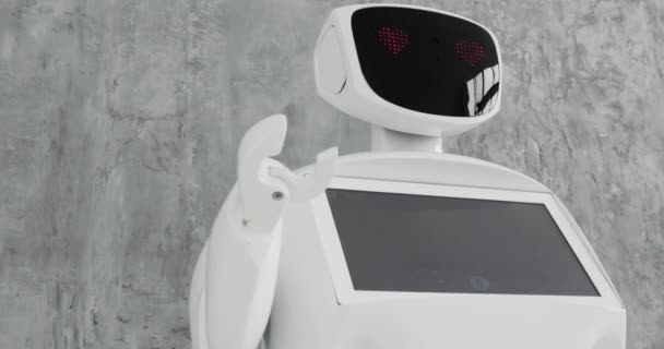 Modern Robotic Technologies. The robot looks at the camera at the person. The robot shows emotions. Raises his hands up, dances or is indignant. Or attacks — Stock Video