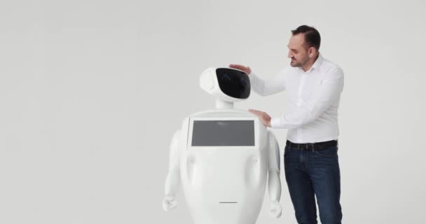 男はロボットをなでます。ロボットとの友情。近代的なロボット技術。人がロボットと通信します。, — ストック動画