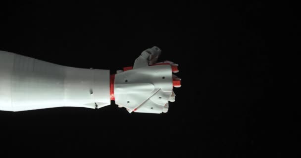 Quality smart robotic programmed prosthesis hand shows rock gesture and victory sign with fingers on black background. — Stock Video