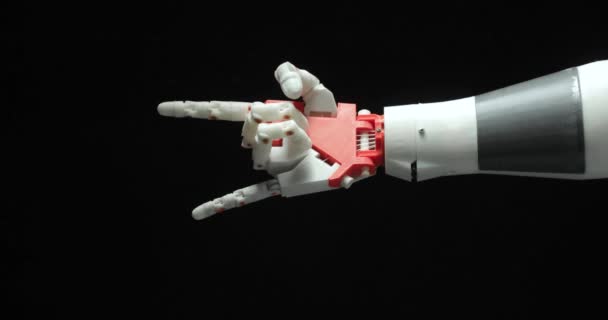 Smart robotic programmed prosthesis hand shows rock gesture, victory and ok sign on black background. — Stock Video