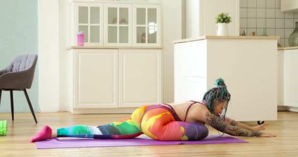 Hippi kadın evde yoga yapıyor. Güvercin pozu veriyor.. — Stok video