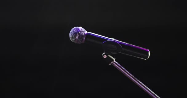 Concert microphone on stage for record or speak to audience on dark background. — Stock Video