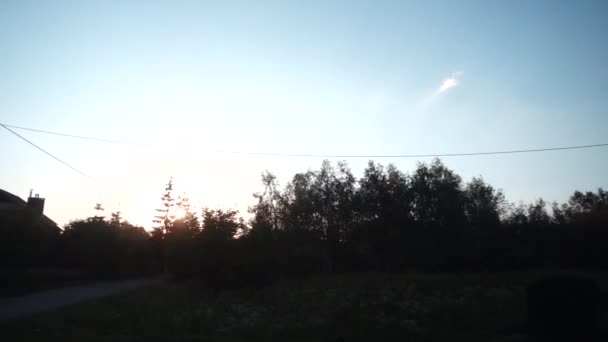 Slow motion against backdrop of sunset in picturesque village. — Stock Video
