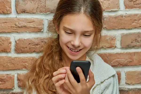 Teenager Girl Long Hair Typing Message Mobile Phone Background Brick — Stock Photo, Image