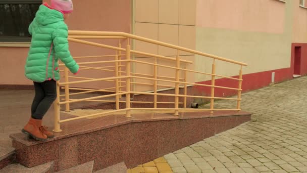 Little Beautiful Girl Autumn Jacket Climbs Metal Railing Building — Stock Video