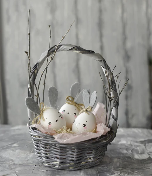 Easter decoration for home, handmade work, cute eggshell rabbit in a basket, beautiful background for card design