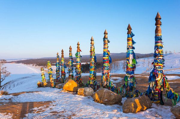 Wooden ritual pillars with colorful ribbons on Olkhon Island, Lake Baikal, Siberia, Russia