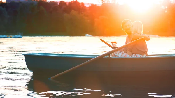 Young couple in a boat on a date in sunlight