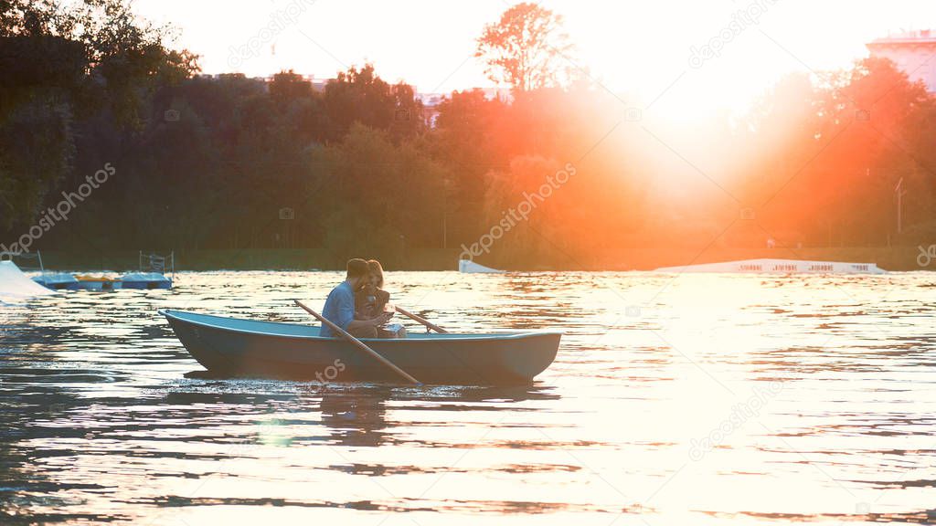 Young couple in a boat on a date in sunlight