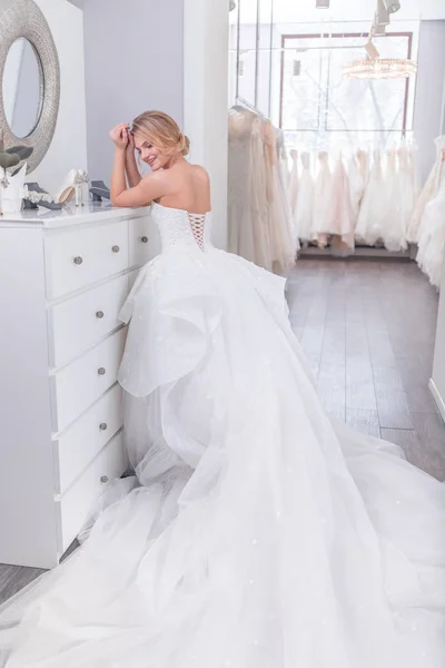 Young woman in white dress in store