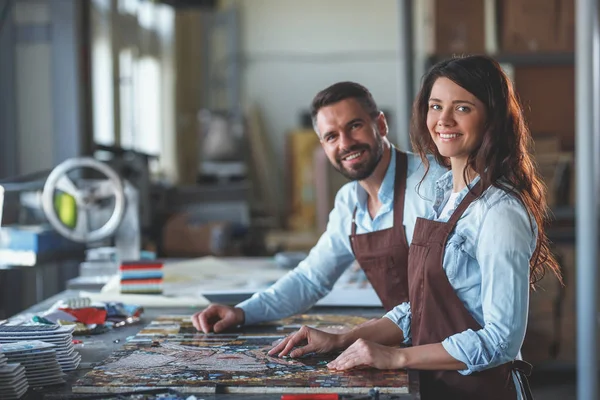 Smiling young people at work in studio