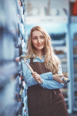 Genç satıcı boya ve depodaki fırçaları ile