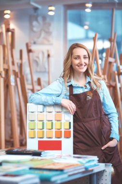 Depodaki apronda gülümseyen genç kız