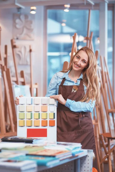 Young girl in uniform in the art shop