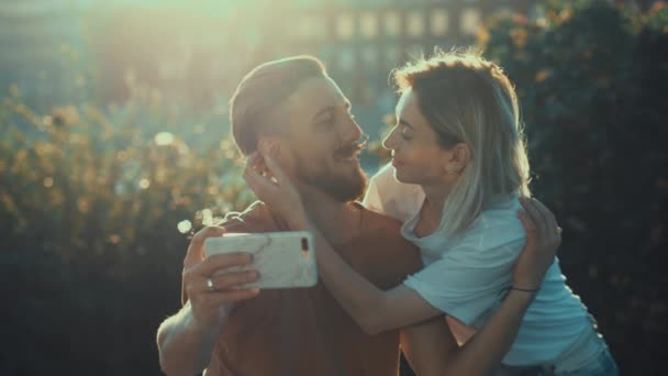 Kissing Young Couple Makes Selfie Outdoors — Stock Video