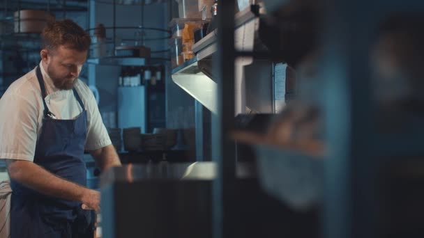 Young Chef Cutting Meat Indoors — Stock Video