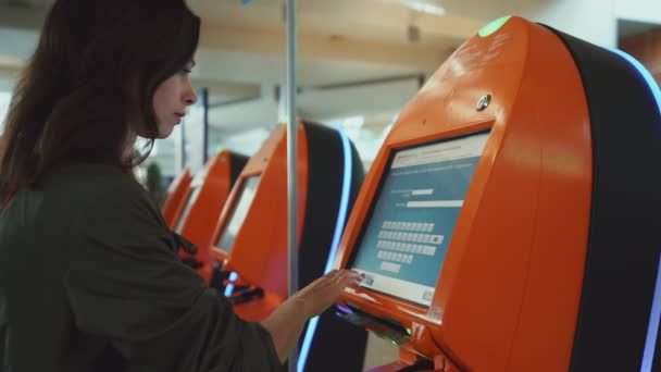 Attractive girl buying a ticket on the screen — Stock Video