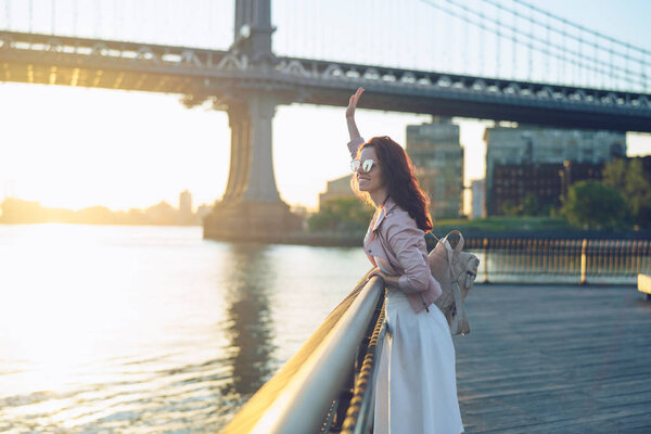 Happy girl in sunglasses at the Manhattan Bridge