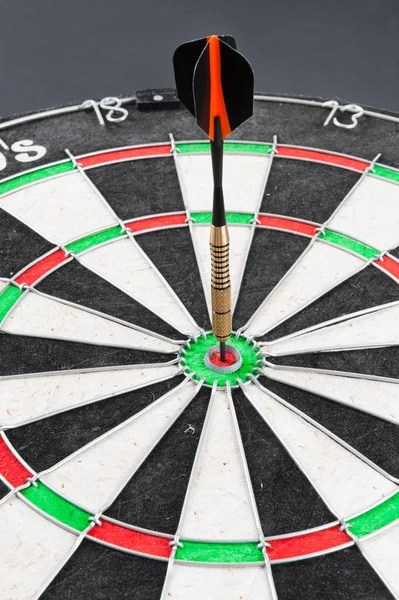 Dartboard with a dart in the center — Stock Photo, Image