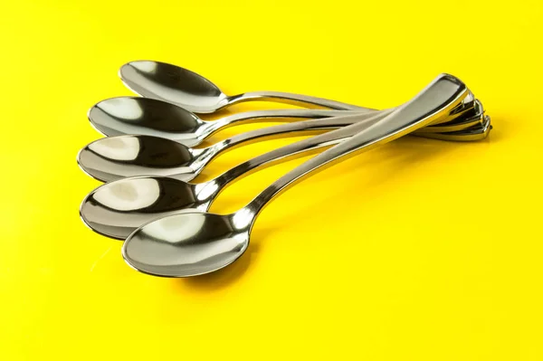 Spoons on yellow — Stock Photo, Image