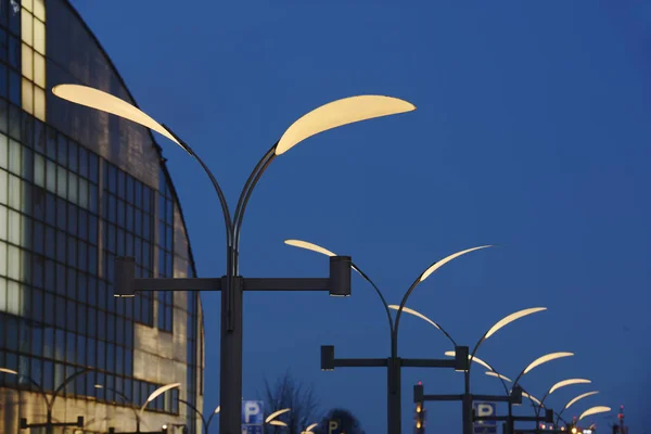 a row of street lights against the night sky, building