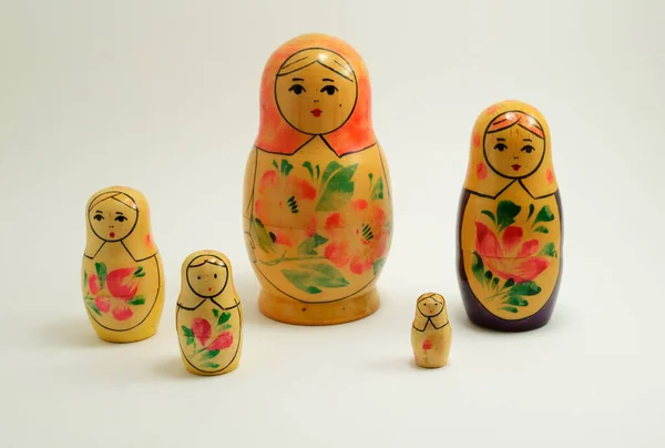 five traditional Russian nesting dolls on white background