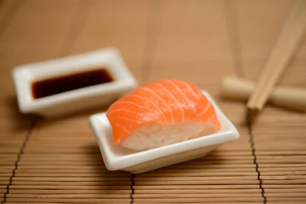 Essstäbchen Sojasauce Und Sushi Mit Lachs Auf Der Bambusmatte — Stockfoto