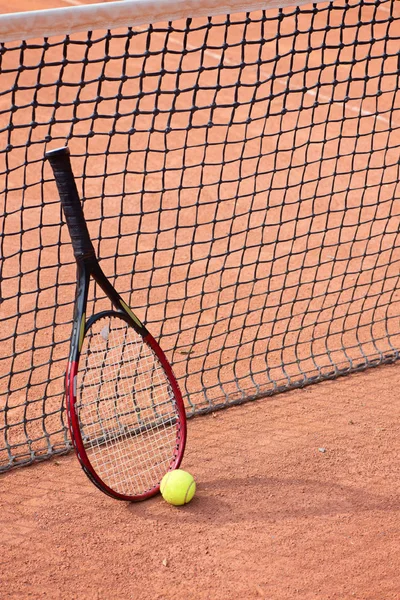 Tennis racket and balls on the clay court Royalty Free Stock Photos