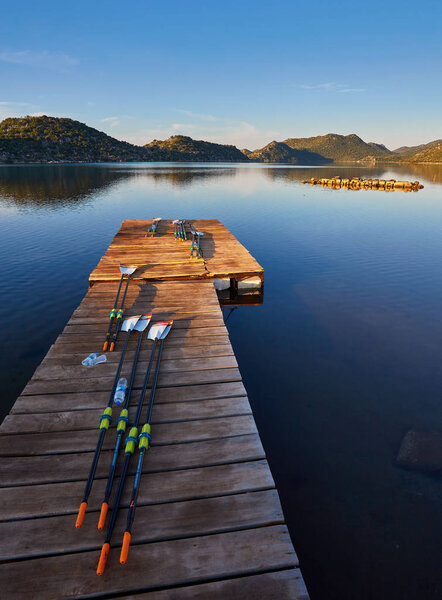 Oars for kayaks lie on the dock, the islands of Kekova at dawn, Turkey