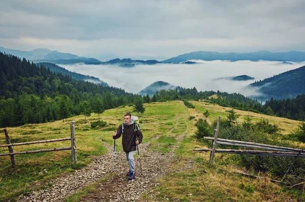 Adam, ağır sırt çantası seyahat yaşam tarzı ile günbatımı Dağları yolculuk tutkusu macera kavramı yaz tatillerini açık yalnız doğaya hiking