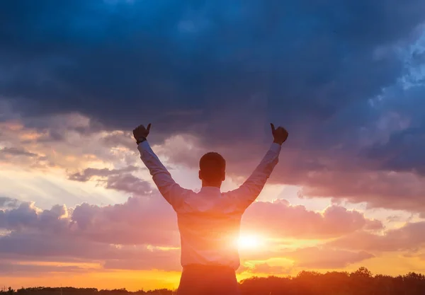 Businessman on green field and sunset — Stock Photo, Image