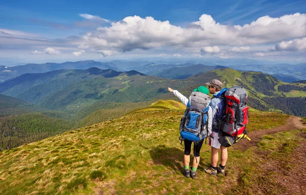 Hombre y mujer de pie y abrazándose en la cima de la montaña, s — Foto de Stock