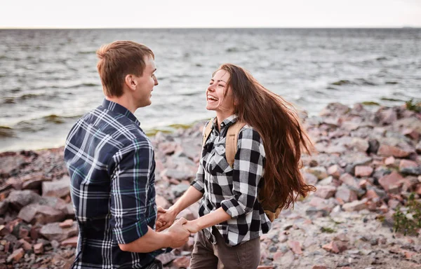 Amantes en un lago. Pareja joven enamorada sentada en el parque groun — Foto de Stock