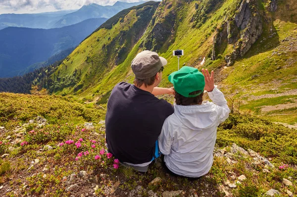 Young couple hiking taking selfie with smart phone.
