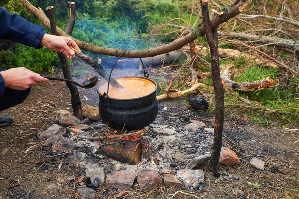 Preparing food on campfire in camping